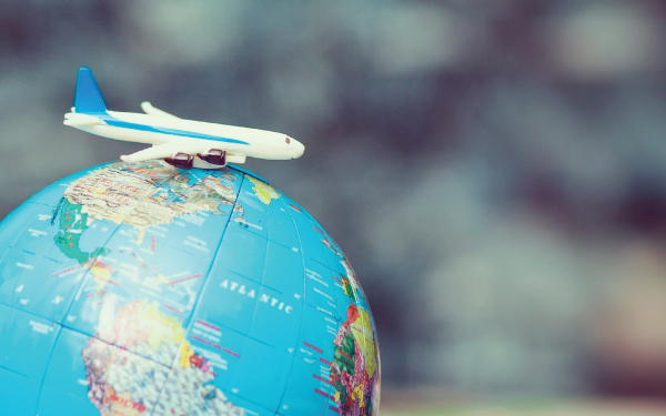 A toy plane on a globe