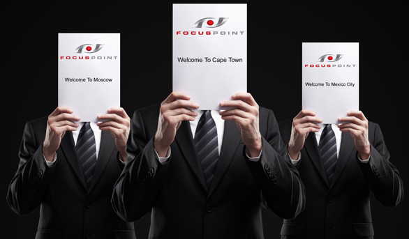 Three of FocusPoint International's Close Protection Body Guards Holidng Up Welcome Signs