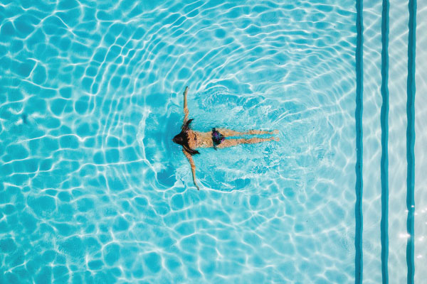 Woman swimming during budget travel