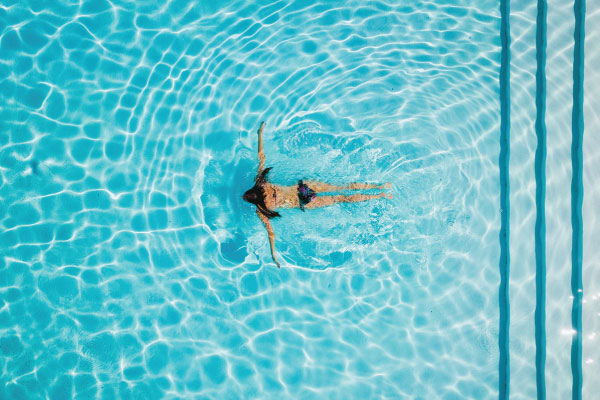 Woman swimming during budget travel Woman swimming during budget travel